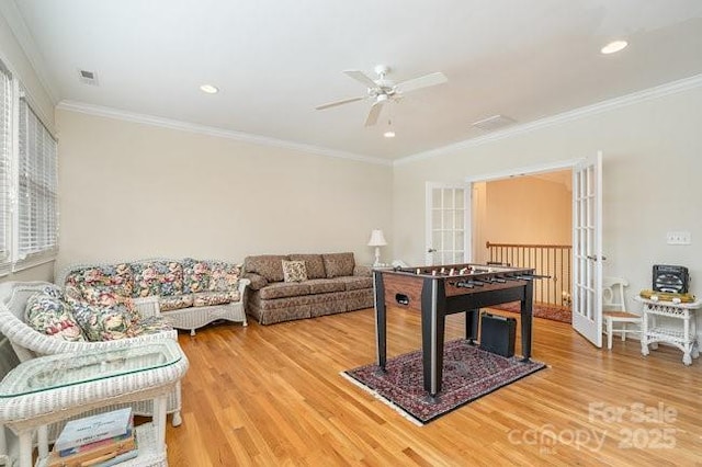 game room with french doors, ceiling fan, wood-type flooring, and crown molding