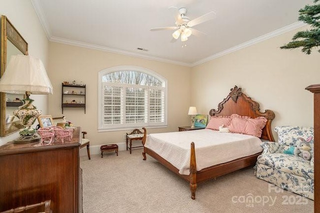 carpeted bedroom with ornamental molding and ceiling fan