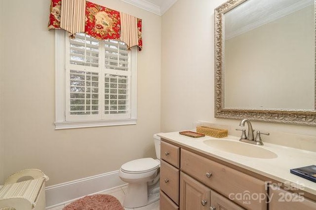 bathroom featuring ornamental molding, toilet, tile patterned flooring, and vanity