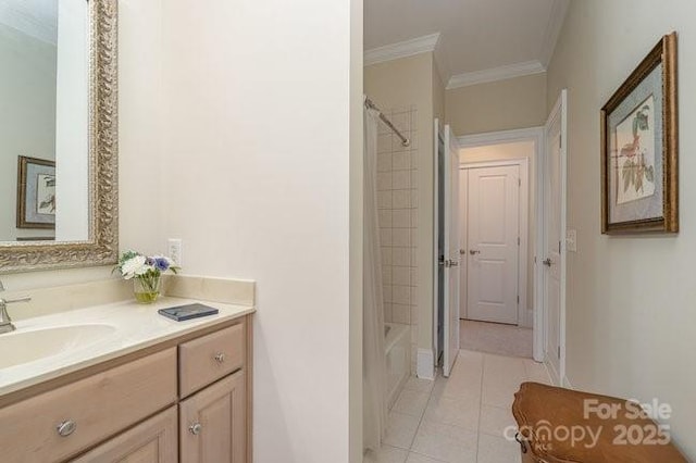 bathroom with crown molding, vanity, tile patterned floors, and tiled shower / bath