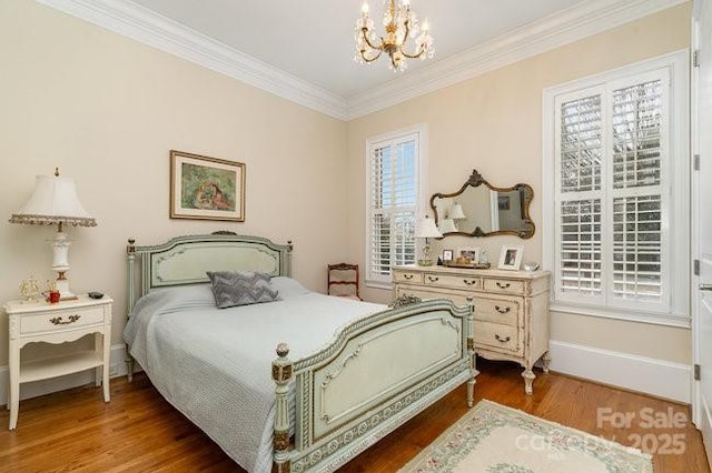 bedroom featuring an inviting chandelier, hardwood / wood-style floors, and ornamental molding