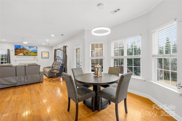 dining area featuring wood-type flooring, a wealth of natural light, and ceiling fan