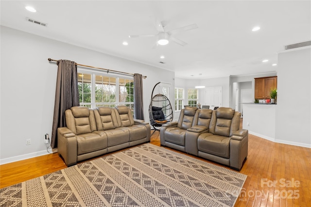 living room with ceiling fan and light wood-type flooring