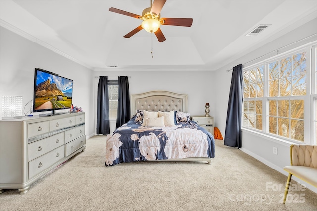 bedroom with crown molding, light colored carpet, and ceiling fan