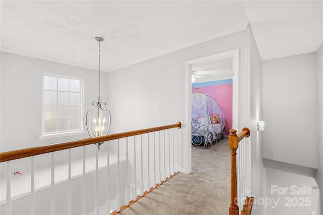 hall with light colored carpet and a chandelier