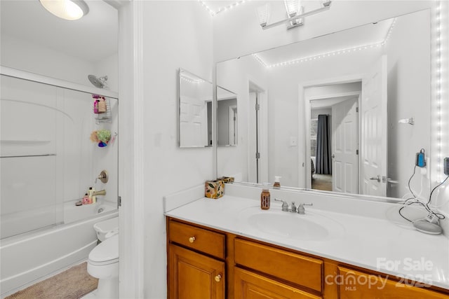 full bathroom with bath / shower combo with glass door, vanity, and toilet