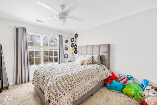 bedroom featuring crown molding, ceiling fan, and light carpet