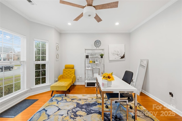 office space featuring light hardwood / wood-style flooring, ornamental molding, and ceiling fan