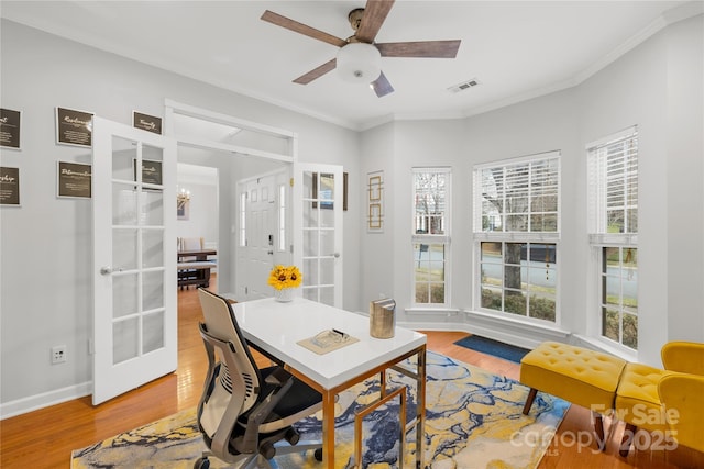 office area featuring hardwood / wood-style flooring, ceiling fan, crown molding, and french doors