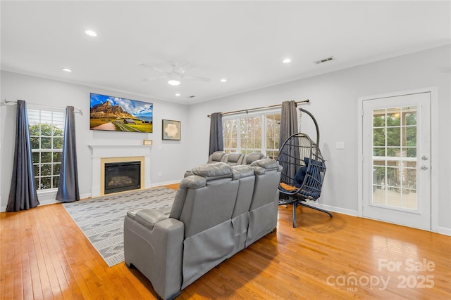 living room with ceiling fan and light wood-type flooring