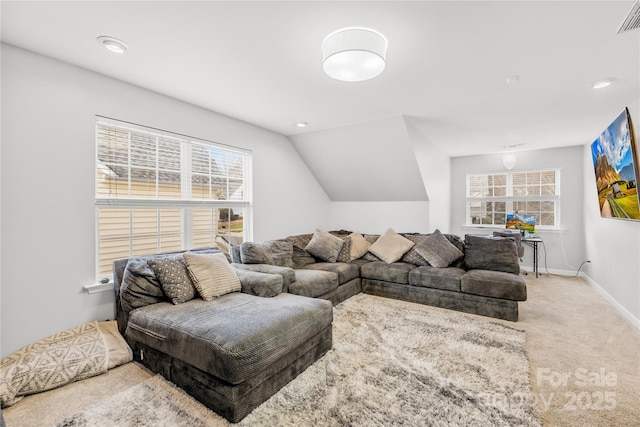 living room featuring lofted ceiling, a healthy amount of sunlight, and carpet floors