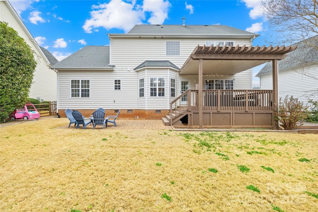 back of property with a yard, a pergola, a deck, and an outdoor fire pit