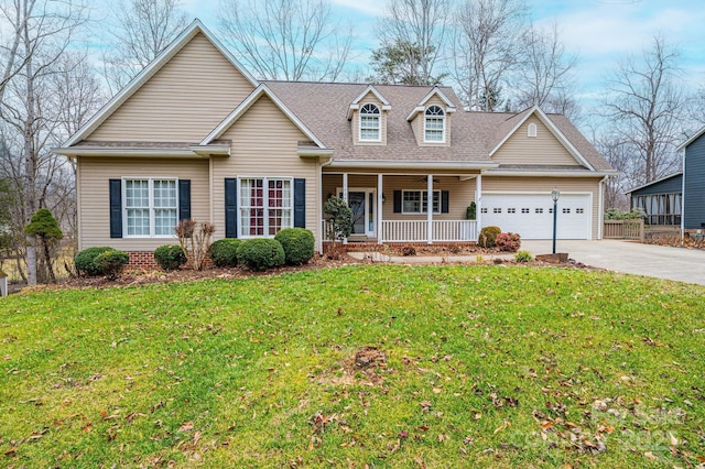 view of front of home with a garage, a front yard, and covered porch