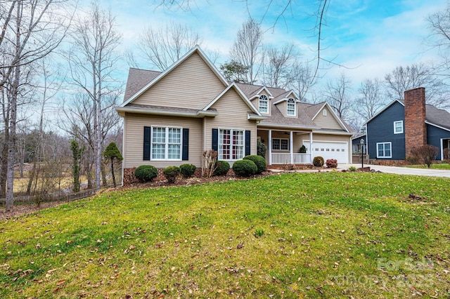 view of front facade featuring a garage, a front yard, and a porch