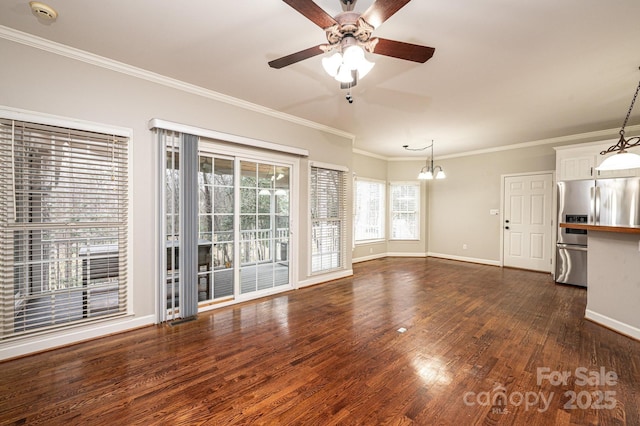 unfurnished living room with dark wood-type flooring, ornamental molding, and ceiling fan with notable chandelier