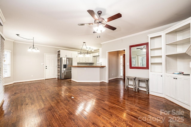 unfurnished living room featuring crown molding, dark hardwood / wood-style floors, and ceiling fan with notable chandelier