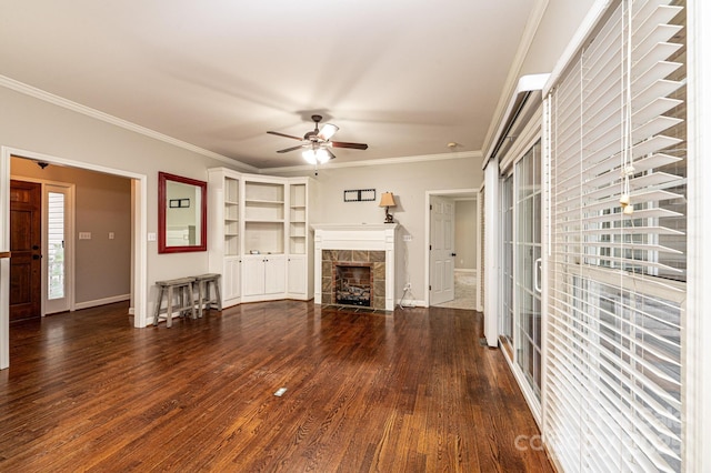 unfurnished living room with crown molding, ceiling fan, a stone fireplace, and dark hardwood / wood-style flooring