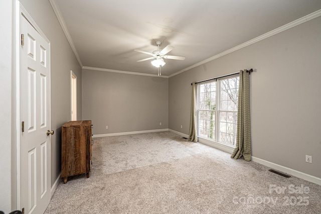 unfurnished bedroom with crown molding, light colored carpet, and ceiling fan