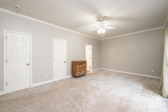 unfurnished bedroom with carpet floors, ornamental molding, and ceiling fan