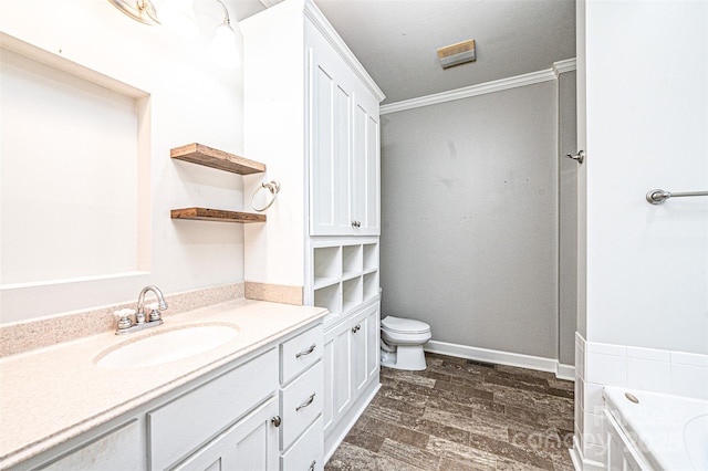 bathroom featuring toilet, crown molding, wood-type flooring, vanity, and a bathing tub