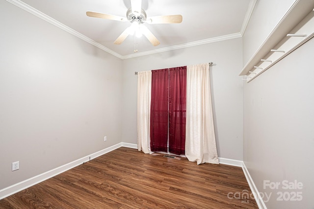 unfurnished room featuring dark wood-type flooring, ceiling fan, and crown molding