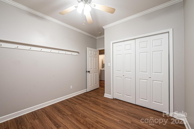 unfurnished bedroom with ornamental molding, dark hardwood / wood-style floors, ceiling fan, and a closet