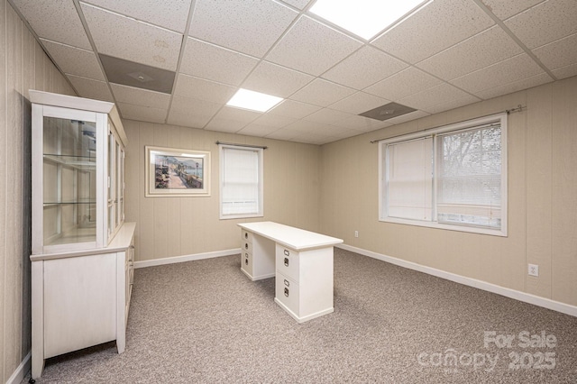 unfurnished office with light carpet and a paneled ceiling