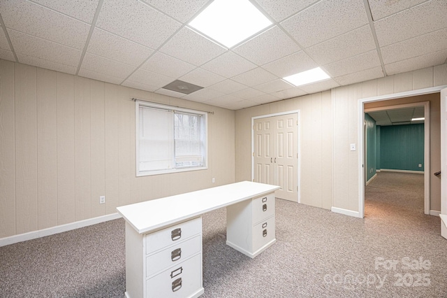 unfurnished office with carpet floors and a drop ceiling