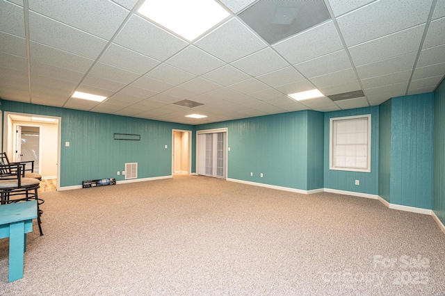 basement with carpet flooring and a drop ceiling