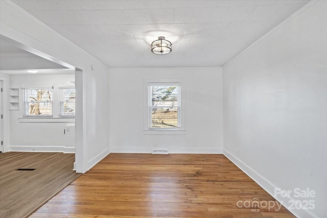 spare room with hardwood / wood-style flooring