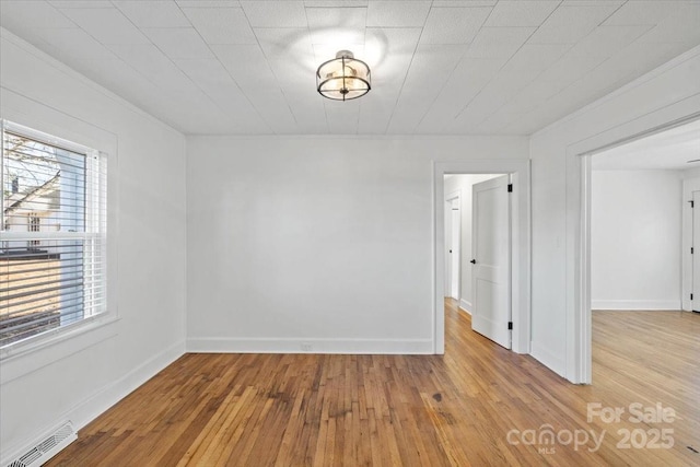 spare room with light hardwood / wood-style flooring