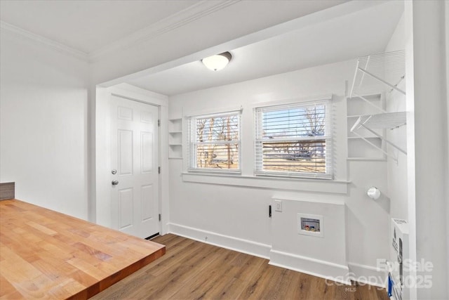 interior space featuring hardwood / wood-style flooring, ornamental molding, and washer hookup