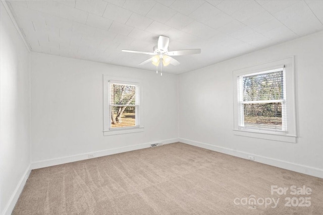 unfurnished room with ceiling fan and light carpet