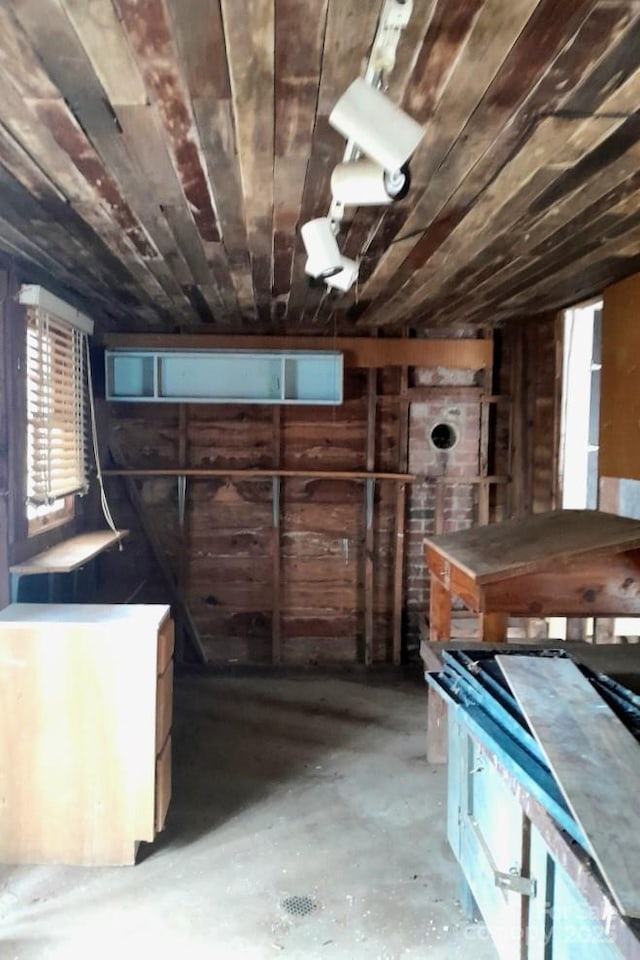 basement with fridge, wood walls, and wooden ceiling