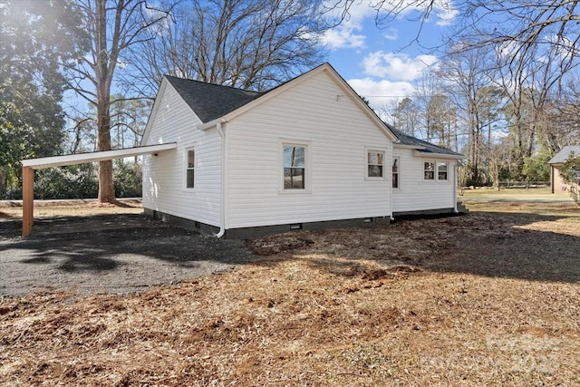 view of side of home with a carport