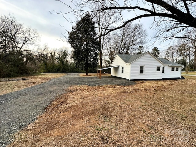 view of side of home featuring a carport