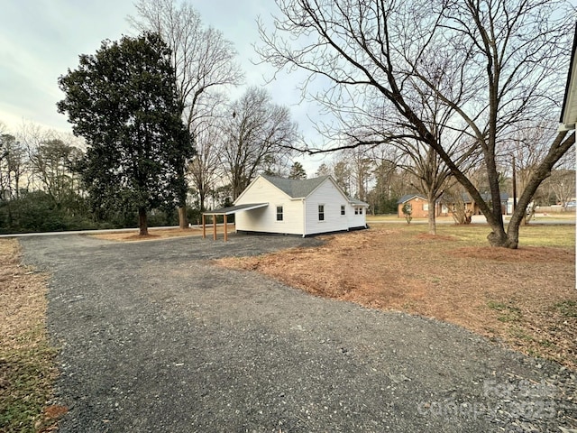 view of property exterior with a carport