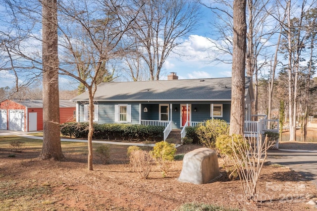 ranch-style home with an outbuilding and a garage