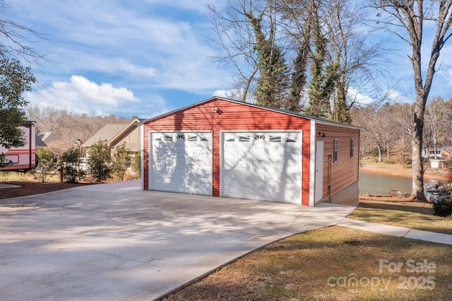 view of outbuilding with a garage and a water view