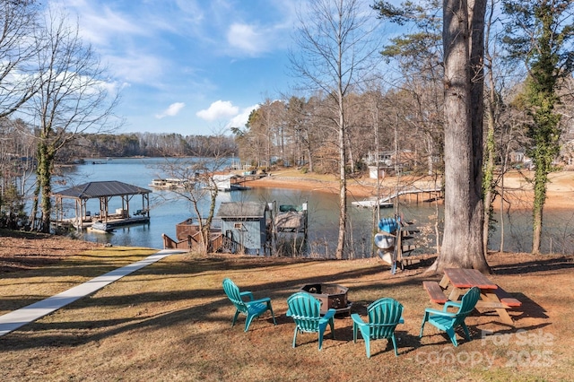 view of dock featuring a water view and a yard