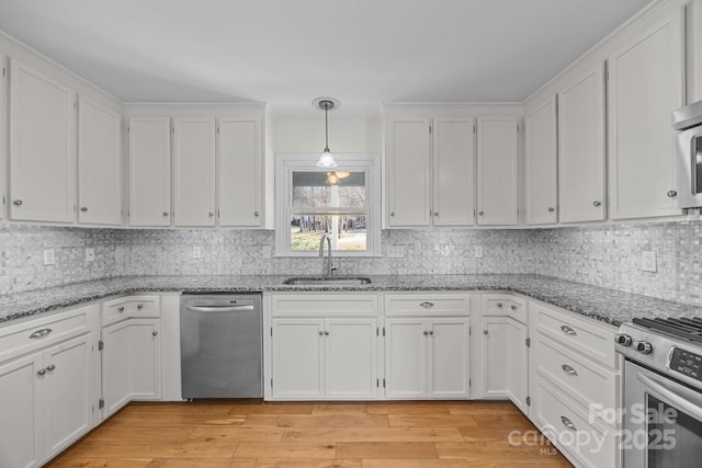 kitchen featuring pendant lighting, sink, and white cabinets