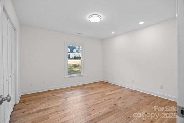 unfurnished bedroom with light hardwood / wood-style floors and a closet