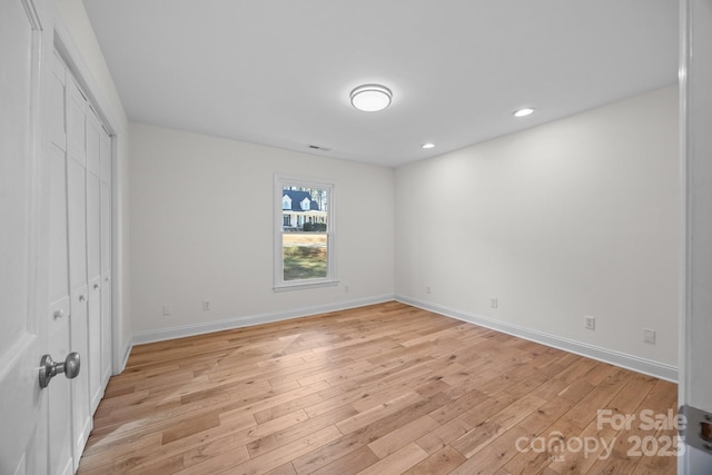 unfurnished bedroom featuring light hardwood / wood-style floors and a closet