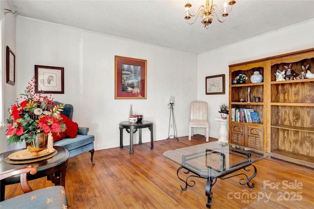 living area with wood-type flooring and a chandelier