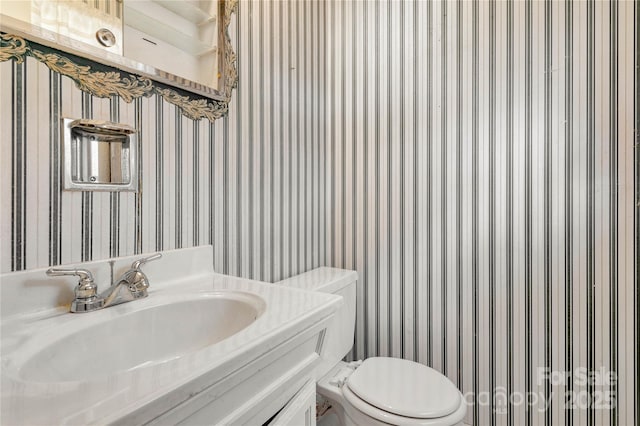 bathroom with vanity and toilet