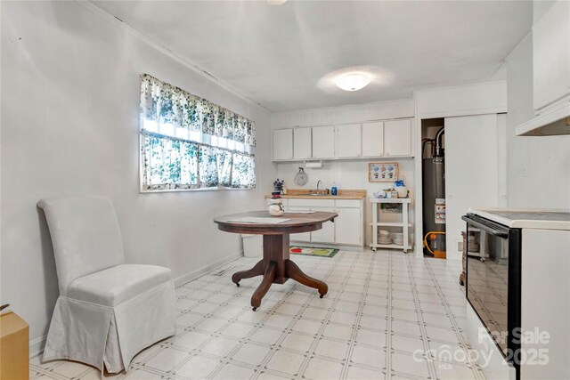 kitchen with white cabinetry, electric range oven, gas water heater, and sink