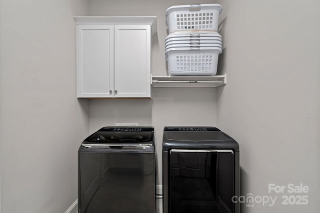 laundry room featuring cabinets and separate washer and dryer