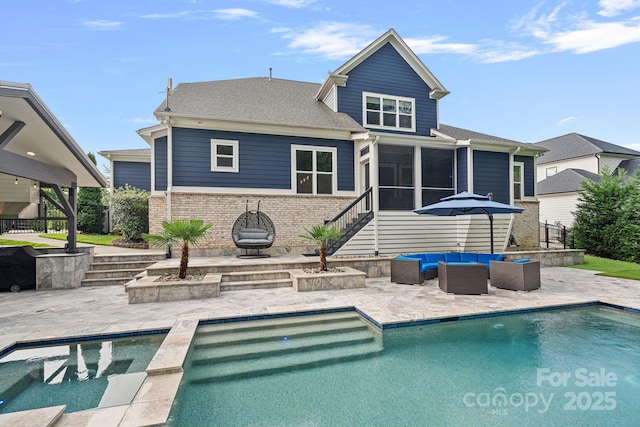 back of property with an outdoor living space, a patio, and a sunroom