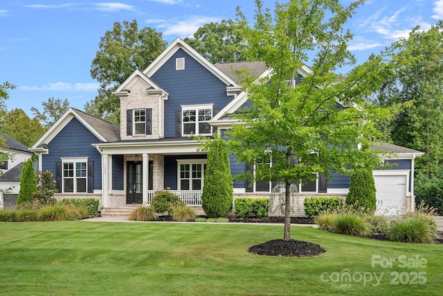 craftsman-style home featuring a garage, covered porch, and a front lawn