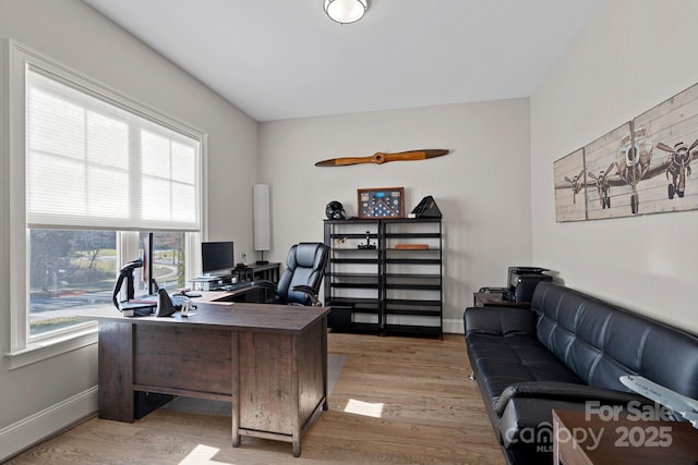 office area with light hardwood / wood-style floors